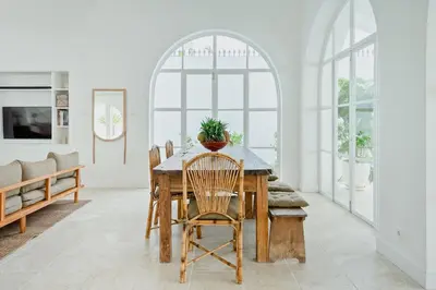 a dining room with a table with a potted plant on it at Luxurious & Bespoke Upscale 3BR Villa in Canggu in Canggu