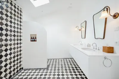 a white bathroom with a black and white checkered floor at Luxurious & Bespoke Upscale 3BR Villa in Canggu in Canggu