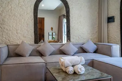 a living room with a couch and a table at Puri Ratu Jimbaran Villa by Betterplace in Jimbaran