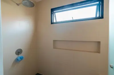 a bathroom with a shower with a window at JB Hazel, 4Bedroom villa in Jimbaran in Jimbaran
