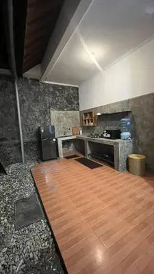 a large kitchen with a wooden floor and a counter at 2 Bedrooms Private Pool Villa Indi K Kerobokan in Seminyak