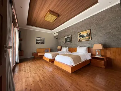 a bedroom with two beds in a room at Villa Jiwanta by Maheswara in Kerobokan