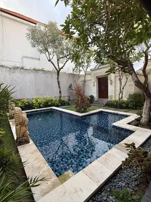 a swimming pool in the middle of a yard at Villa Jiwanta by Maheswara in Kerobokan