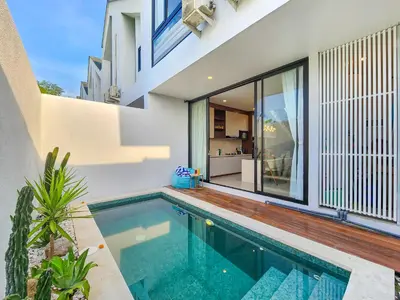 a swimming pool in the backyard of a house at Villa Sorano Seminyak by Nagisa Bali in Seminyak