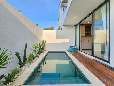 a swimming pool in the backyard of a house at Villa Sorano Seminyak by Nagisa Bali in Seminyak