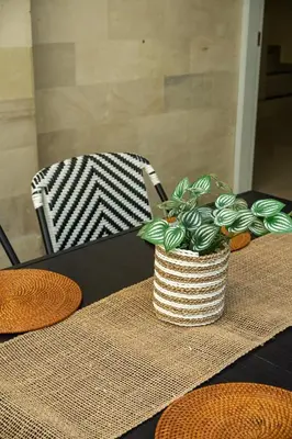 a table with a potted plant on top of it at Prime Location Seminyak 3BR Pool Villa in Seminyak