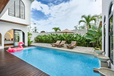 a pool with a pink swan in a house at Jivani Villa - 9 min to Nusa Dua Beach - Brand New, Cinema Room, BBQ, 3Bdr in Jimbaran