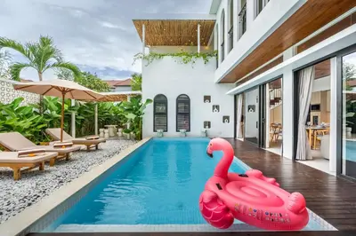 an inflatable pink swan in the swimming pool of a villa at Jivani Villa - 9 min to Nusa Dua Beach - Brand New, Cinema Room, BBQ, 3Bdr in Jimbaran