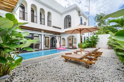 an exterior view of a villa with a swimming pool at Jivani Villa - 9 min to Nusa Dua Beach - Brand New, Cinema Room, BBQ, 3Bdr in Jimbaran