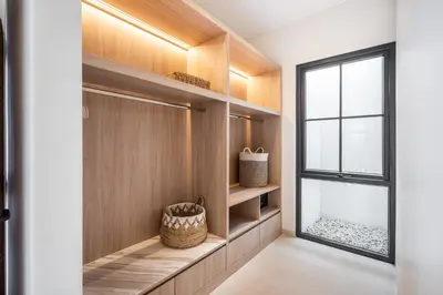 a walk in closet with a window and a basket at Jivani Villa - 9 min to Nusa Dua Beach - Brand New, Cinema Room, BBQ, 3Bdr in Jimbaran