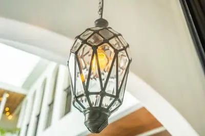 a glass light fixture hanging from a ceiling at Jivani Villa - 9 min to Nusa Dua Beach - Brand New, Cinema Room, BBQ, 3Bdr in Jimbaran