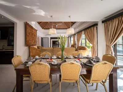 a dining room with a table and chairs at Villa Cometa Luxury Seminyak by Adam Jyota Management in Seminyak