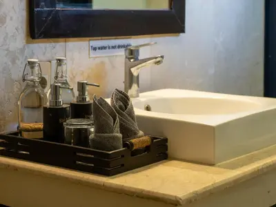 a bathroom sink with a tray next to a sink at Villa Cometa Luxury Seminyak by Adam Jyota Management in Seminyak