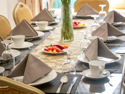 a long table with plates of food and napkins at Villa Cometa Luxury Seminyak by Adam Jyota Management in Seminyak
