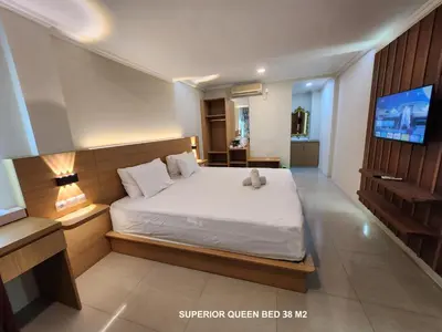 a bedroom with a white bed and a television at Bali Balitung in Seminyak