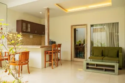 a kitchen and living room with a couch and a table at Bali Balitung in Seminyak