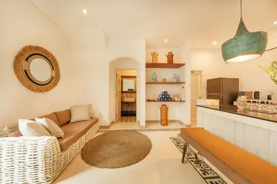 a living room with a couch and a table at Stylish 3BR Escape, 5 Mins to Seminyak Beach in Seminyak