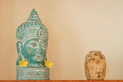 a statue of a head and a vase on a table at Stylish 3BR Escape, 5 Mins to Seminyak Beach in Seminyak