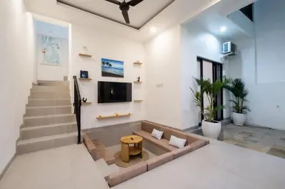 a living room with a couch and a tv at La Casa Gomes in Nusa Dua