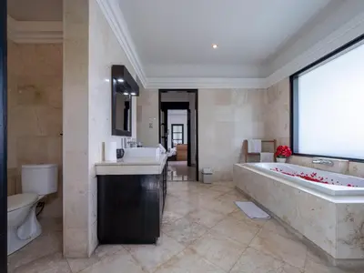 a large bathroom with a large tub and a large window at Villa Cometa Prime Seminyak by Adam Jyota Management in Seminyak