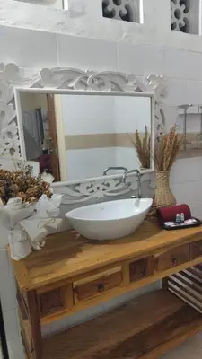 a bathroom with a white sink and a mirror at Villa Harmony Moon in Denpasar