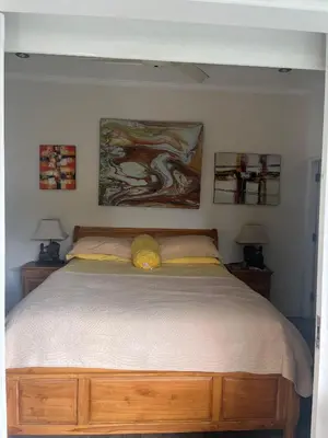 a bedroom with a large bed with two lamps at Villa Harmony Moon in Denpasar