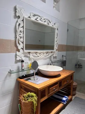 a bathroom with a sink and a mirror at Villa Harmony Moon in Denpasar