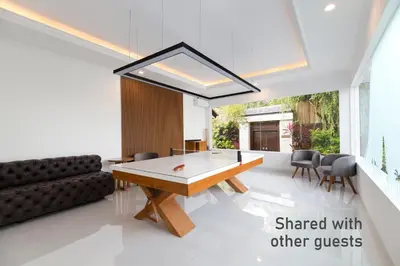 a living room with a ping pong table and a couch at Villa Mia Seminyak - Boutique Villas - I in Seminyak