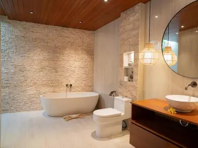 a bathroom with a tub and a toilet and a sink at Harbie Villa 2 in Badung