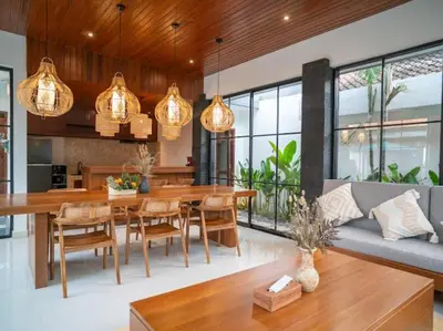 a kitchen and dining room with a table and chairs at Harbie Villa 2 in Badung