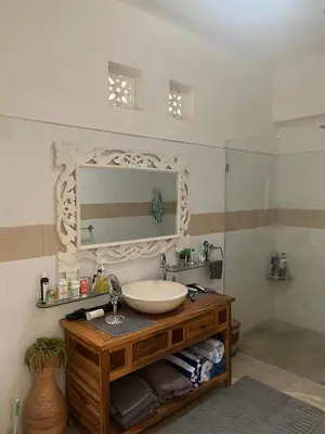 a bathroom with a sink and a mirror at Villa Harmony Moon in Seminyak