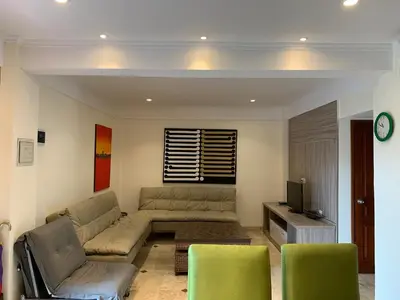 a living room with a couch and a tv at The Jayakarta Residence 2BR Bali in Denpasar