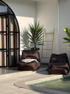 two brown bags sitting next to a potted plant at Villa Jiji cozy chic in Bali - just renovated ! in Canggu