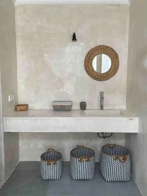 a bathroom with a sink and three baskets under it at Villa Jiji cozy chic in Bali - just renovated ! in Canggu