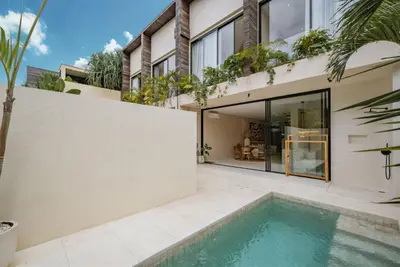 an image of a house with a swimming pool at Villa Nazare Berawa in Canggu