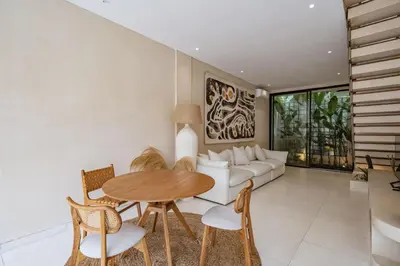a living room with a table and a couch at Villa Nazare Berawa in Canggu