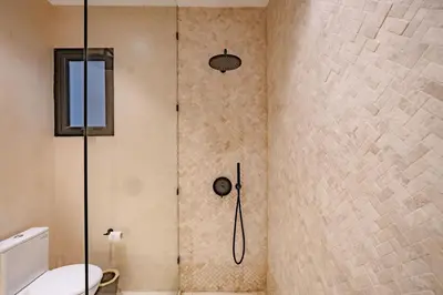 a bathroom with a shower with a toilet at Villa Nazare Berawa in Canggu