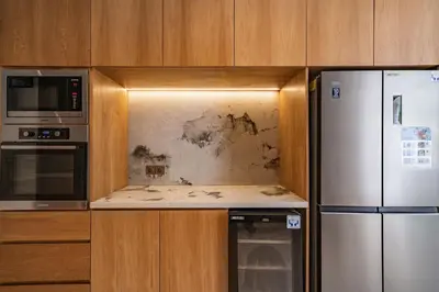 a kitchen with a stove and a refrigerator at Villa Nazare Berawa in Canggu