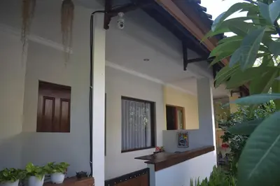 a hallway of a house with potted plants at Banana Room Near to Kuta Legian Beach in Legian