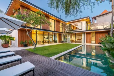 an exterior view of a house with a swimming pool at Villa Semilir Sendja, Canggu in Canggu
