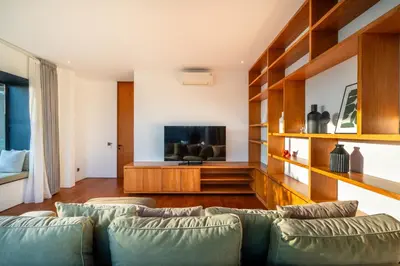 a living room with two couches and a flat screen tv at Villa Semilir Sendja, Canggu in Canggu