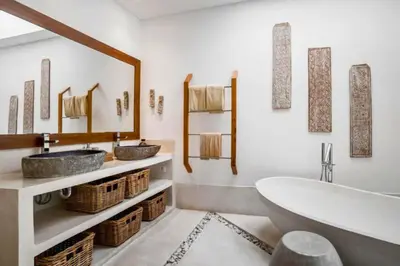 a bathroom with two sinks and a bath tub at Feodora Peaceful 4 BR Private Pool Villa in Seminyak