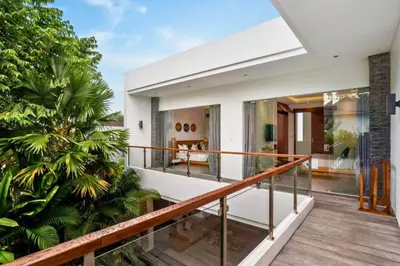 a balcony with a view of a house at Feodora Peaceful 4 BR Private Pool Villa in Seminyak