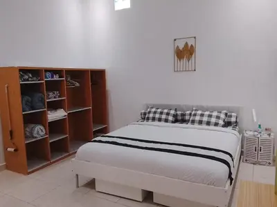 a bedroom with a bed and a closet at Kuta Grace house Bali in Kuta