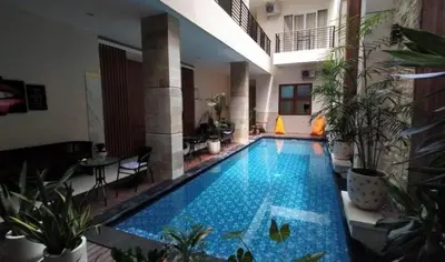 a large swimming pool in the middle of a building at Ultimate Residence in Seminyak