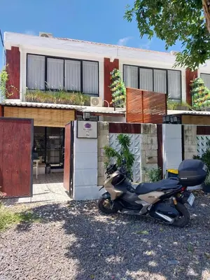 a motorcycle parked in front of a house at Villa 2 Kavi Minimalis 1 Kamar Di Sanur in Sanur