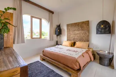 a bedroom with a bed and a sink and a window at Adena Modern Paradise 3 BR Private Pool Villa in Kerobokan