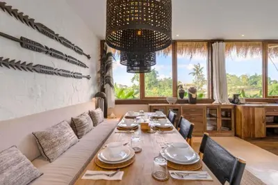 a dining room with a long table and chairs at Adena Modern Paradise 3 BR Private Pool Villa in Kerobokan