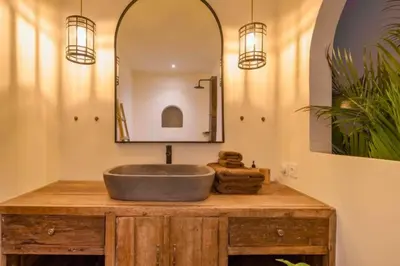 a bathroom with a sink and a mirror at Adena Modern Paradise 3 BR Private Pool Villa in Kerobokan