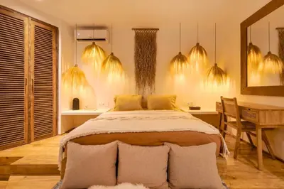 a bedroom with a large bed and a desk at Adena Modern Paradise 3 BR Private Pool Villa in Kerobokan